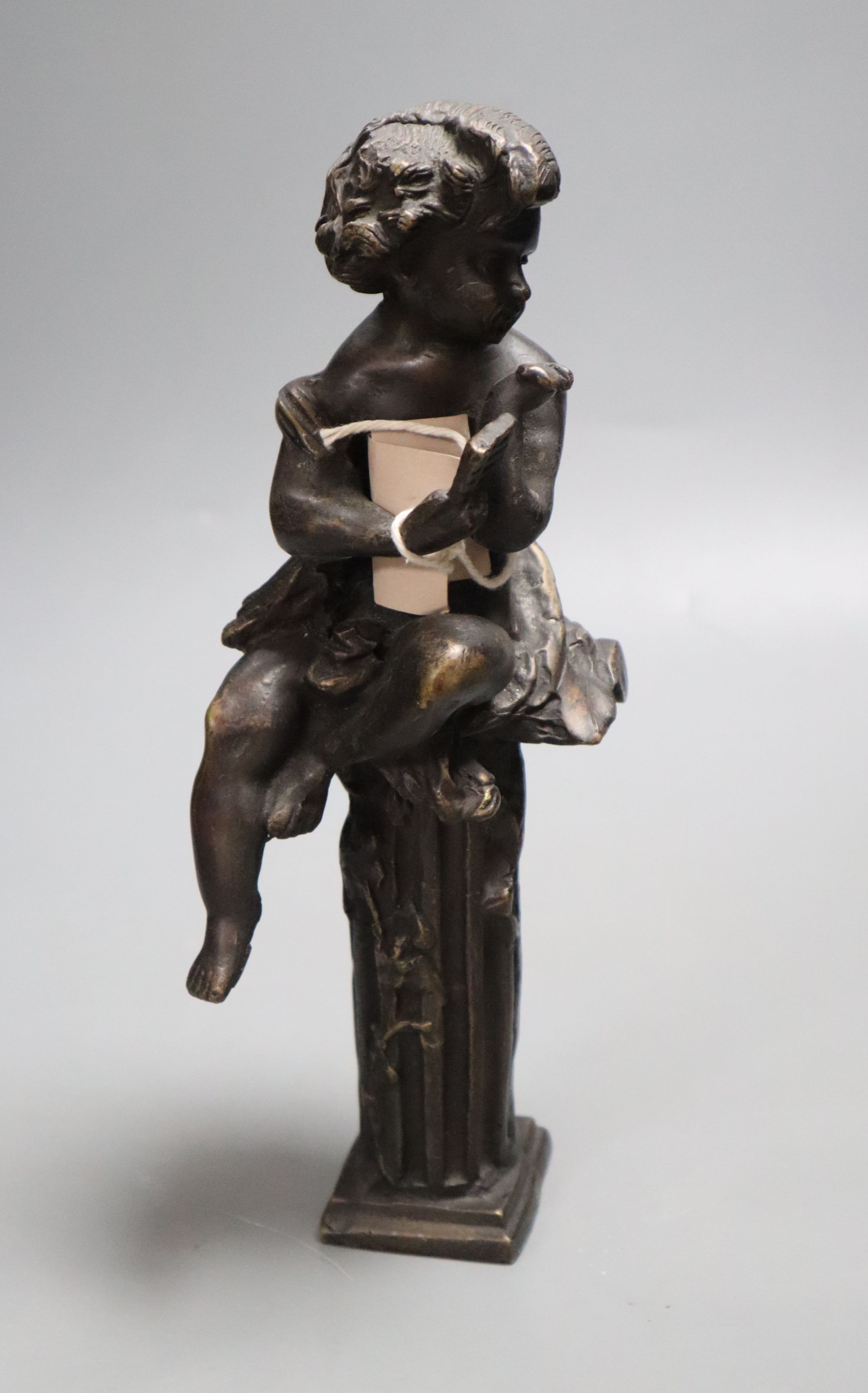 A decorative bronze cherub on pedestal, height 26cm